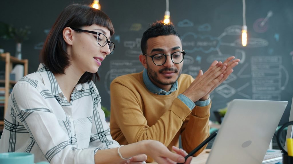 Small business professionals discussing cybersecurity planning in an office